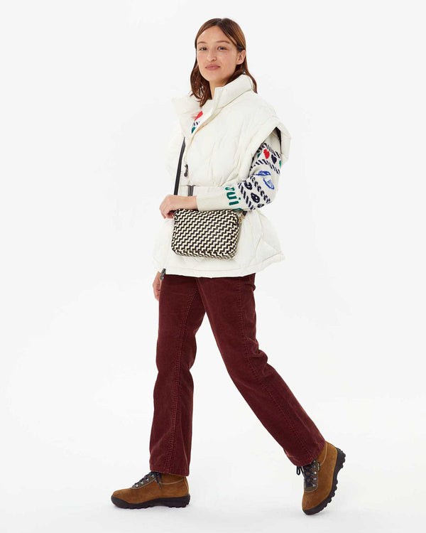 Zoe in corduroy pants and the icon sweater with the Pryenex Diana Vest in Milk on