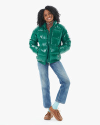 Mecca wearing the Vintage Mythic Puffer Coat in Forest Biome with jeans over a floral turtleneck