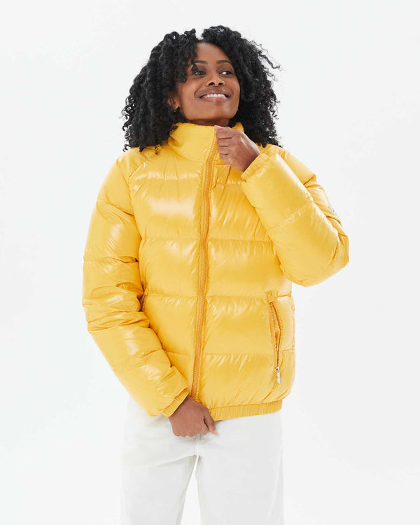 Mecca zipping up the Vintage Mythic Puffer Coat in Yolk