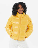 Mecca wearing the Vintage Mythic Puffer Coat in Yolk with white pants