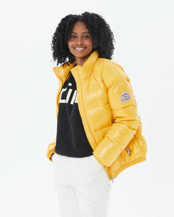 Mecca with her hands in the pockets of her pants in the Vintage Mythic Puffer Coat in Yolk