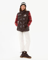 Zoe wearing the John 2 Vest in Java with a plaid sweater and white pants with Yogi Footwear shoes