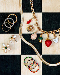 Paco Charm Shown on the Charm Chain Necklace with assorted CV Charms Alongside the Freshwater Pearl Flower Stud Earrings, assorted Stacking Rings, and the 24 Inch Snake Chain Necklace