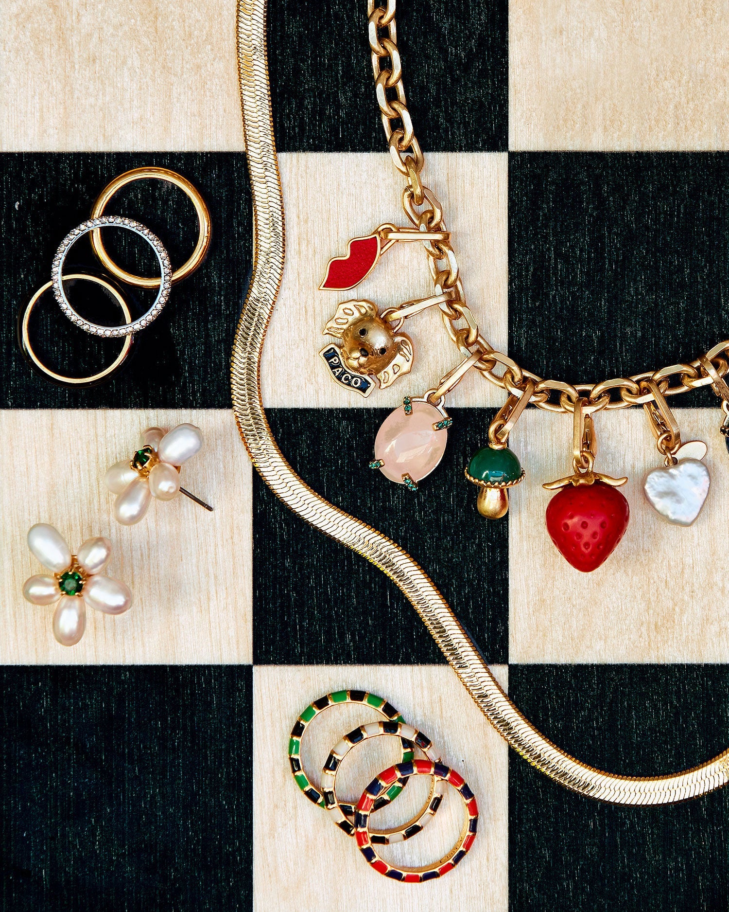 Paco Charm Shown on the Charm Chain Necklace with assorted CV Charms Alongside the Freshwater Pearl Flower Stud Earrings, assorted Stacking Rings, and the 24 Inch Snake Chain Necklace