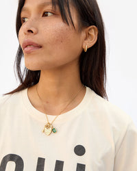 Maly wearing the Vintage Gold La Clé Charm with other assorted charms on the charm chai necklace