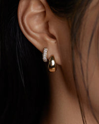 model wearing the Kinn Studios Pavé Diamond Dome Huggies in her second piercing hole