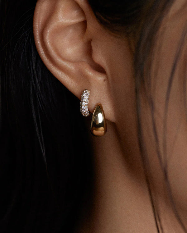 model wearing the Kinn Studios Pavé Diamond Dome Huggies in her second piercing hole