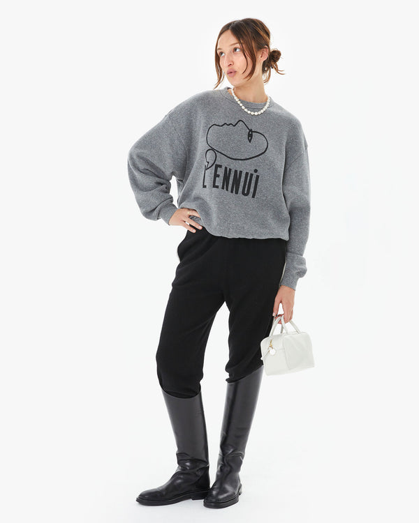 Zoe wearing the Grey L'Ennui Oversized Sweatshirt with black pants and riding boots