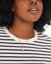Candice wearing the Petit Heart Locket on the  silver box chain necklace