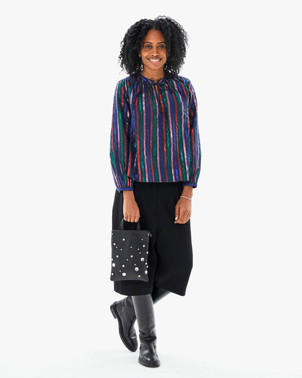 Mecca in the Multi Stripe Thea Blouse with black capris, black riding boots with the Black with Stones Petit Mick