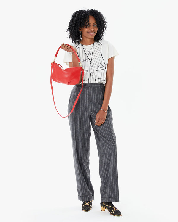 Mecca holding the Rogue Petit Moyen in her right hand by her shoulder