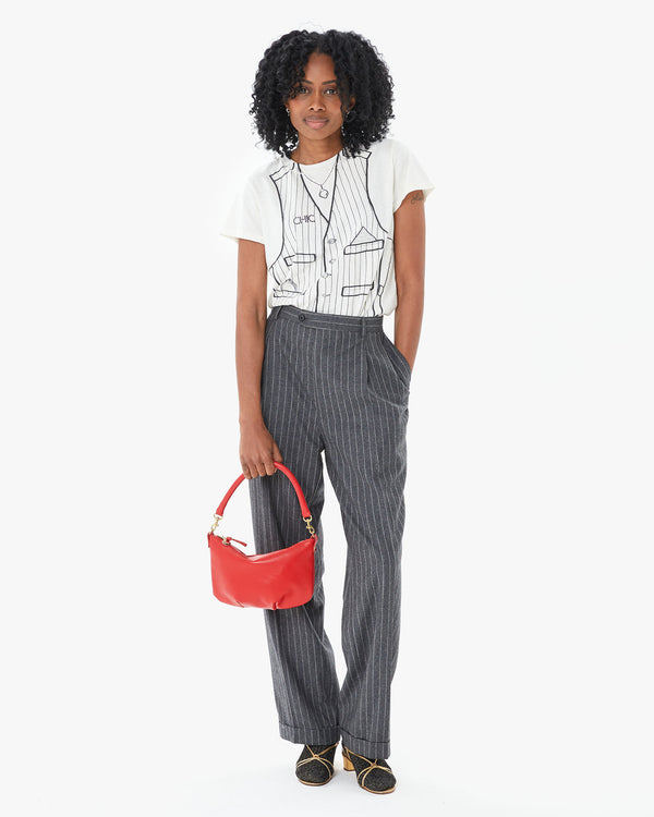 Mecca in suit pants with the Cream Trompe l’oeil Vest Classic Tee tucked in with the rouge petit moyen 