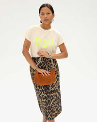 Maly in a leopard print skirt holding the suede petit moyen by the Silver Shortie Strap
