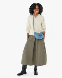 Mecca wearing the Jean Similaire Woven Checker Petit Moyen crossbody over a cream sweater and the Anais Skirt