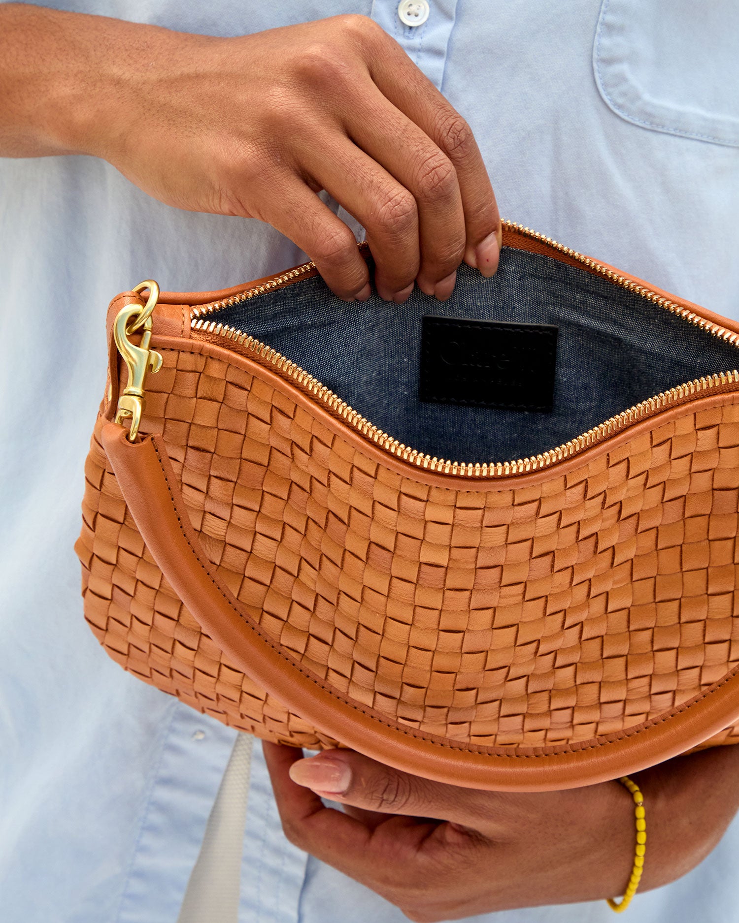 Model showing the Chambray lining of the Natural Woven Petit Moyen.