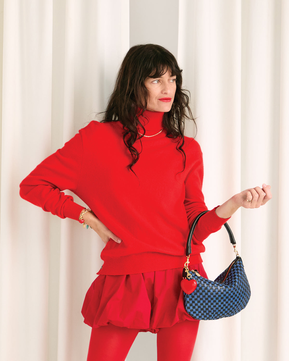 Model carrying the Cobalt/Black Petit Moyen with Red Heart Fob attached to it.