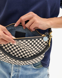 Sandra shows the interior view of the Black & Cream Woven Checker Petit Moyen Messenger