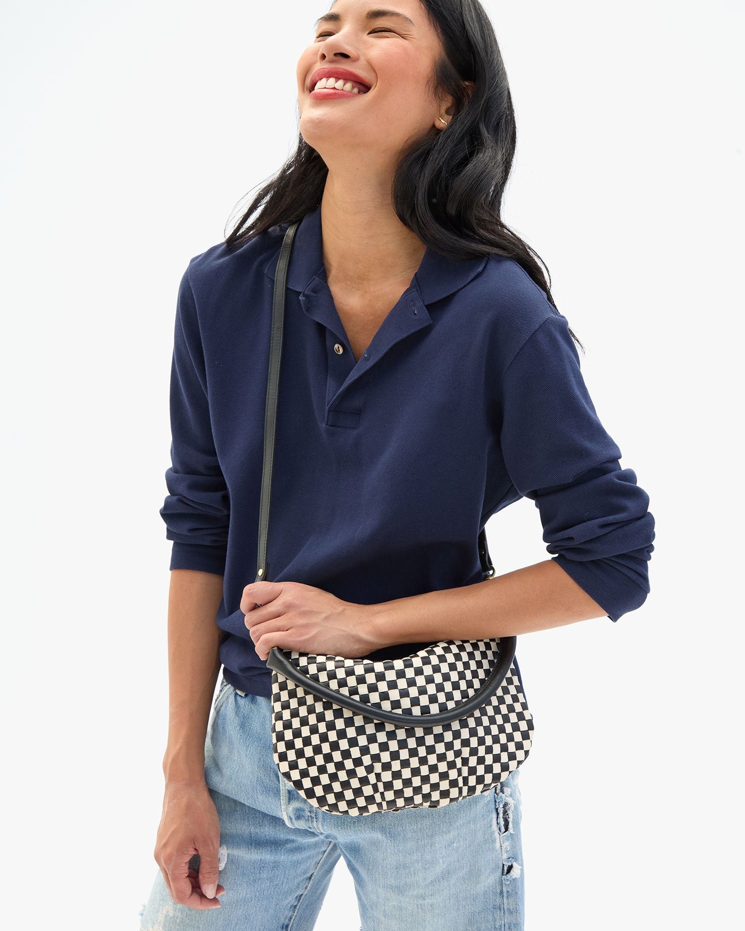 Sandra wears the Black & Cream Woven Checker Petit Moyen Messenger as a crossbody