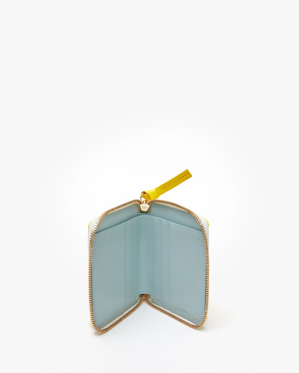 Interior of the Dandelion Petit Zip Wallet. Interior is an aqua blue color. 