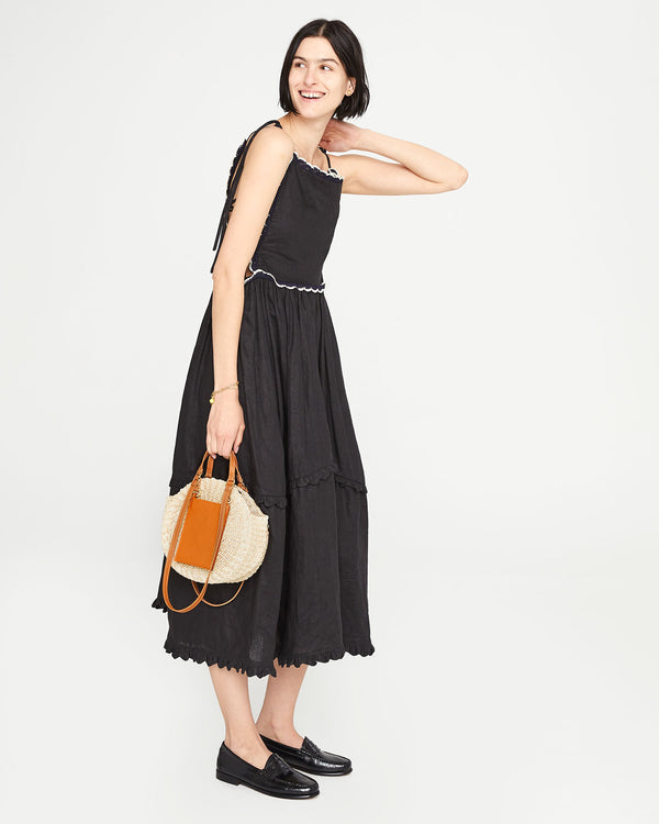 Athena carrying the Cream and Cuoio Poche Moyen Alice by the top handles. 