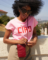 Mecca wearing the Oxblood w/ Tiger Deboss Poche Sporttif crossbody