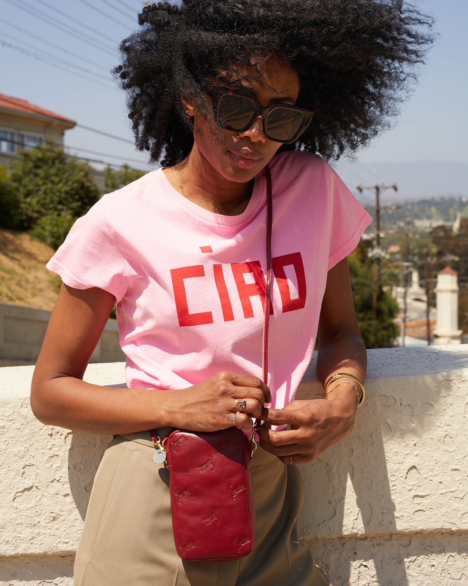 Mecca wearing the Oxblood w/ Tiger Deboss Poche Sporttif crossbody