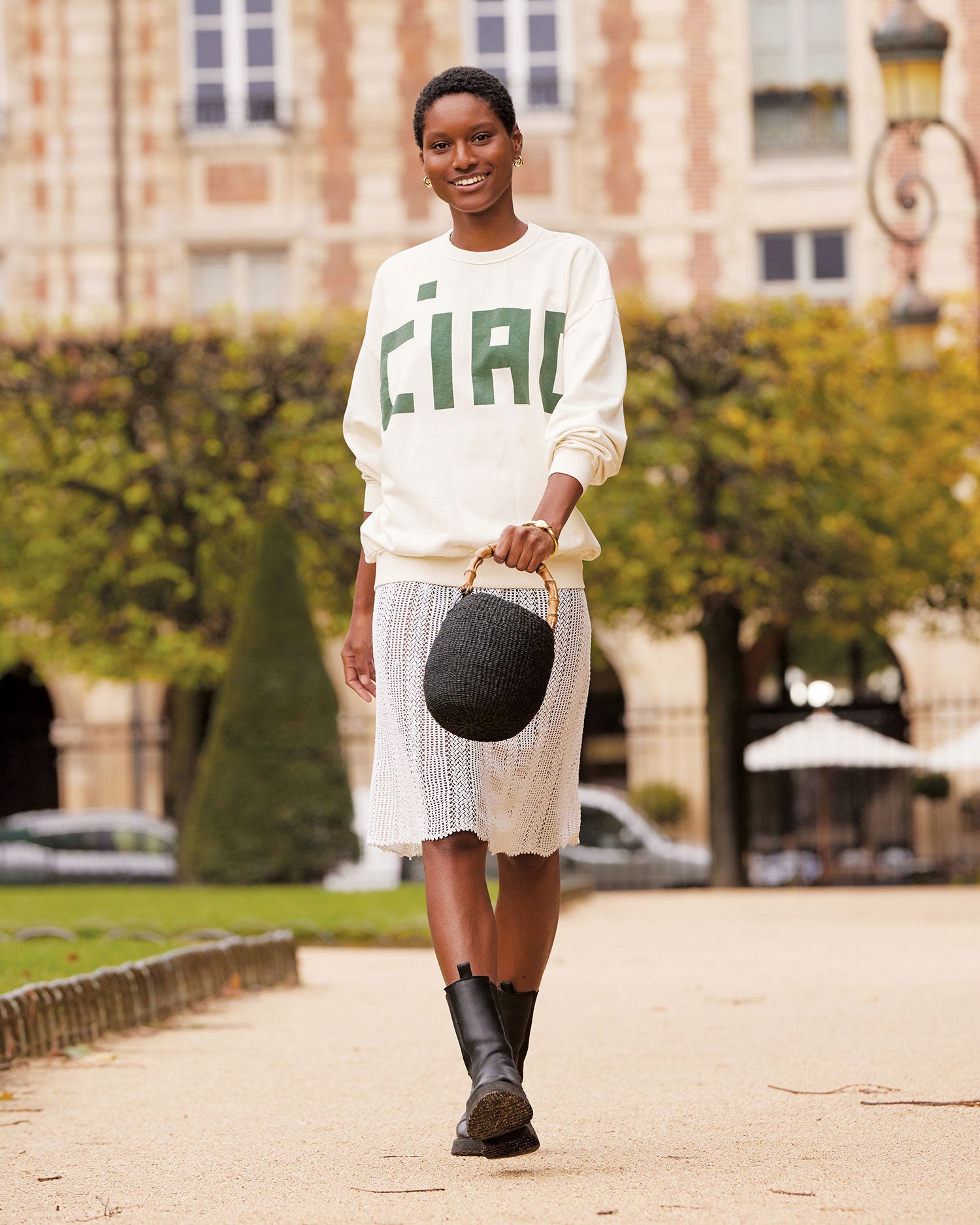 Aurelie Strolls in Paris Holding the Pot de Miel in Black with Bamboo Handle