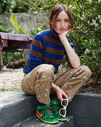 Model wearing the CV x Monoprix Cobalt with Brown Stripes Ribbed Turtleneck with the CV x Monoprix Khaki Cargo Pants.