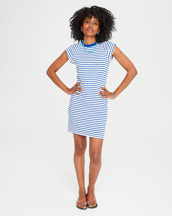 Mecca with both hands on her hips in the Cobalt and Cream Petit Stripe Raglan Tank Dress with flip flops