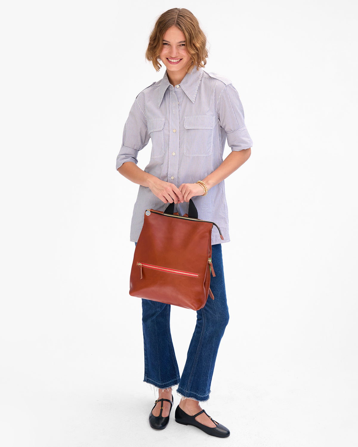 Florencia holds Remi by the top handle