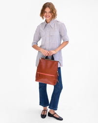 Florencia holds Remi by the top handle