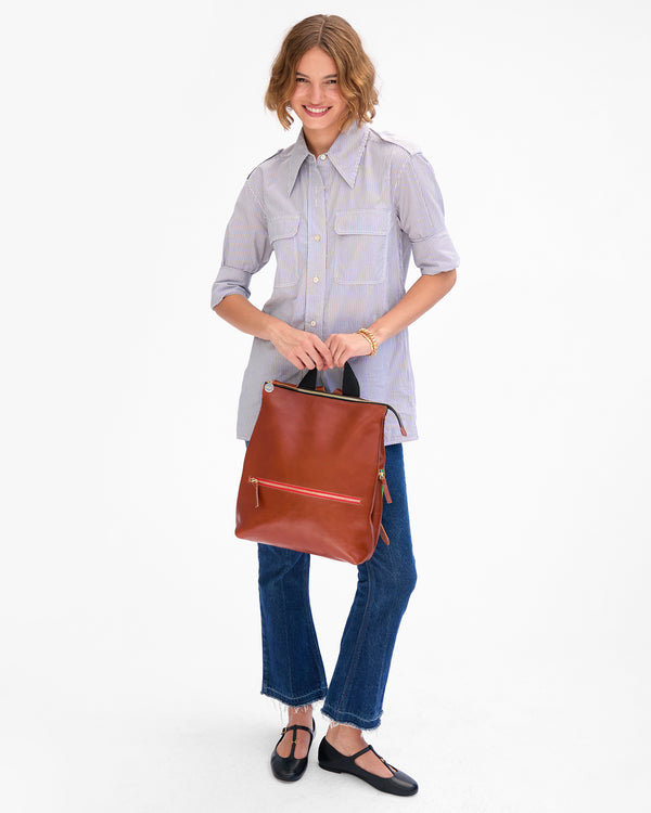 Florencia holds Remi by the top handle