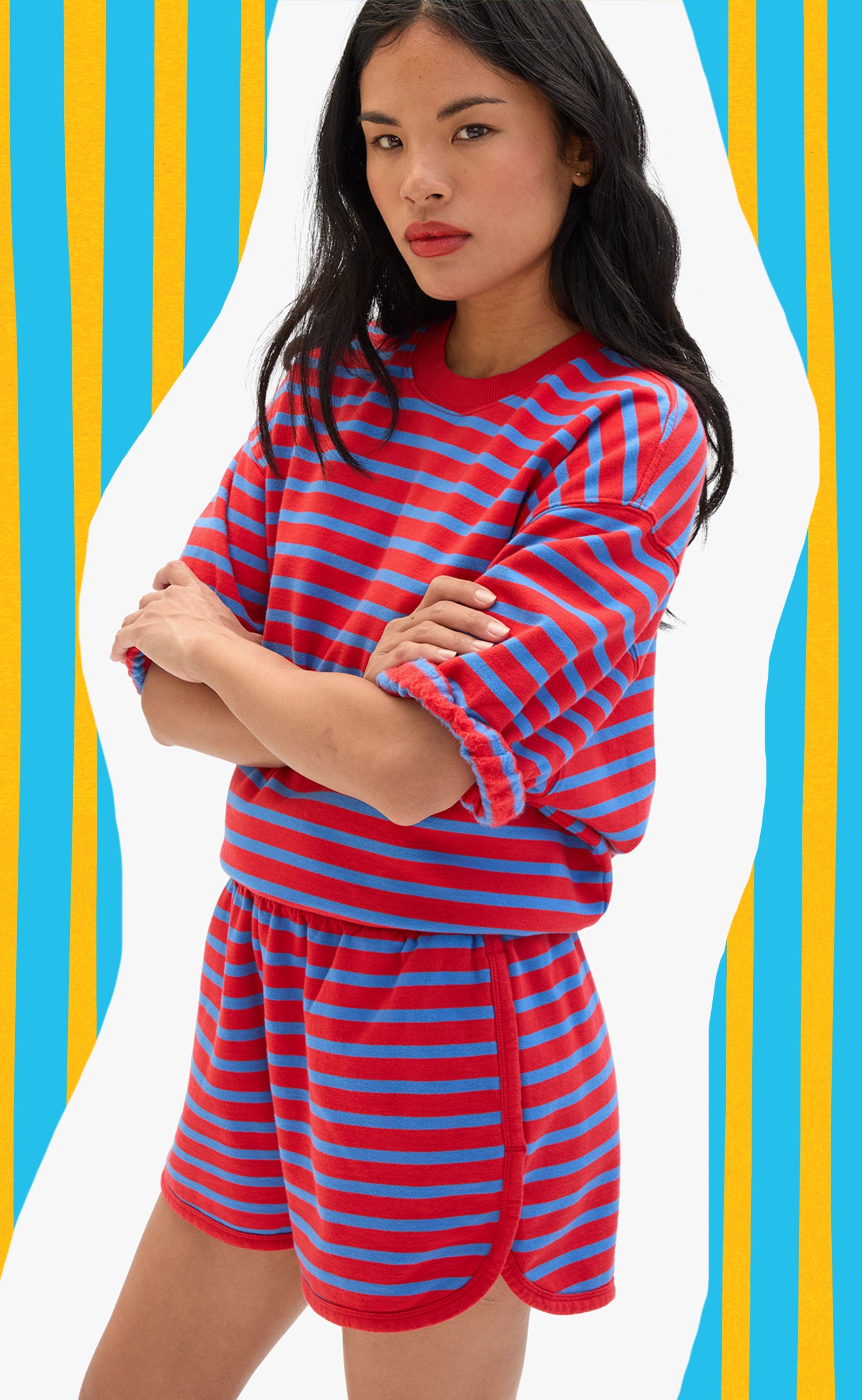 Model wearing the Red and Bright Cobalt Stripes Sweatshirt and Matching Shorts set. 