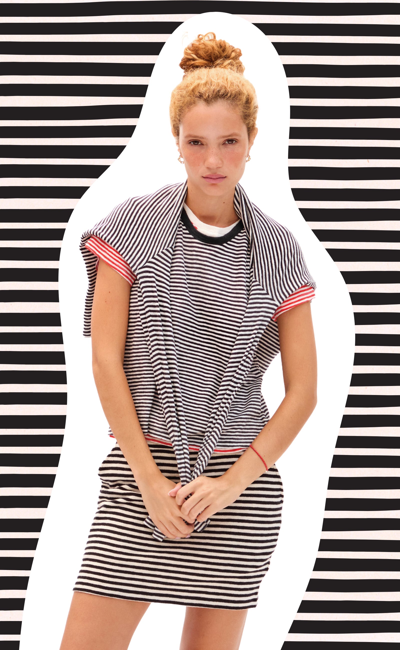 Model wearing the striped Le Mini Tube skirt with striped tops. 