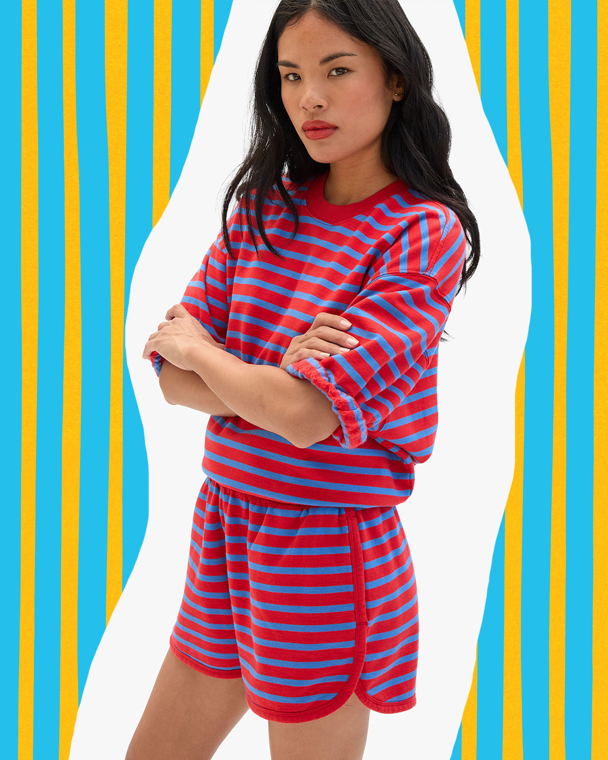 Model wearing the Red and Bright Cobalt Stripes Sweatshirt and Matching Shorts set. 