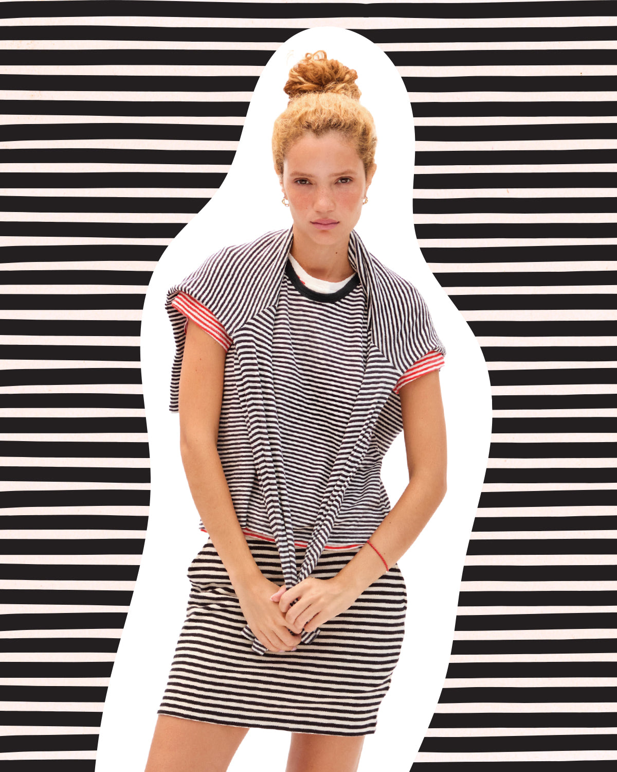Model wearing the striped Le Mini Tube skirt with striped tops. 