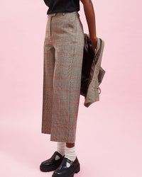 Model wearing the Grey Plaid w/ Orange Stitch Suit Pants with black loafers