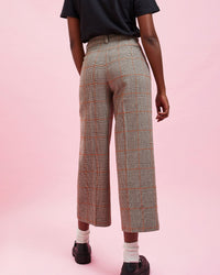 back view of the model wearing the Grey Plaid w/ Orange Stitch Suit Pants