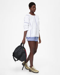 Mouna holding Sac Tout Backpack