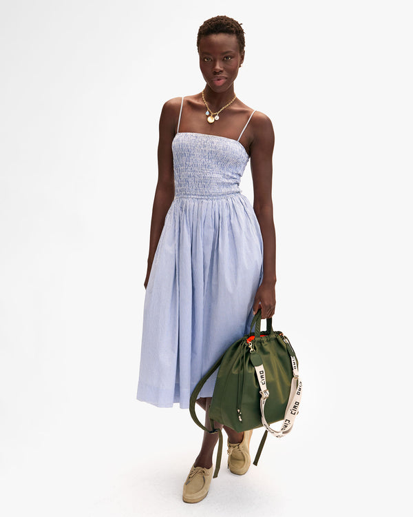 Dija holding Sac Tout Backpack