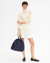 Nike holds Sac Tout in Navy Recycled Nylon by the top handle