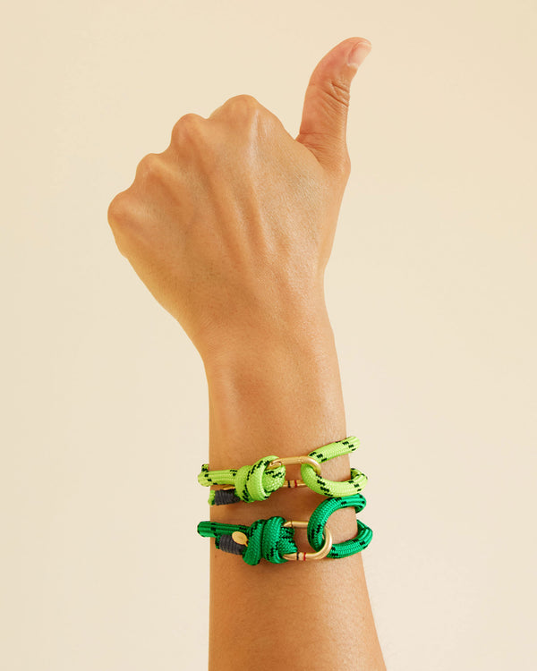 Andrea doing a thumbs up while wearing the yellow and green Sailcord Bracelets.