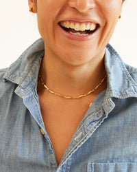 andrea wearing a denim shirt and a big smile with the vintage gold Sardine Chain Necklace on 