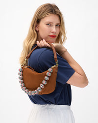 Model carrying the Hazelnut Petit Moyen with Multi Enamel Stripe Shortie Strap. 