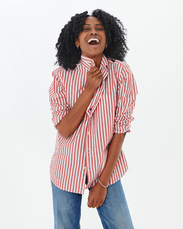 mecca laughing and holding the collar of the  Poppy & cream Stripe Single Needle Shirt