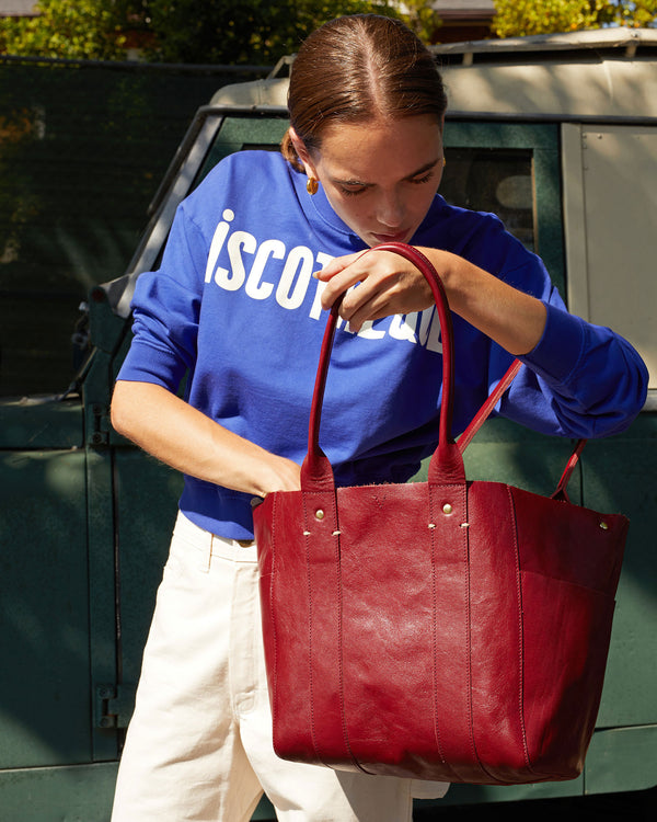 Lillian looking inside the Oxblood Rustic Le Slim Box Tote