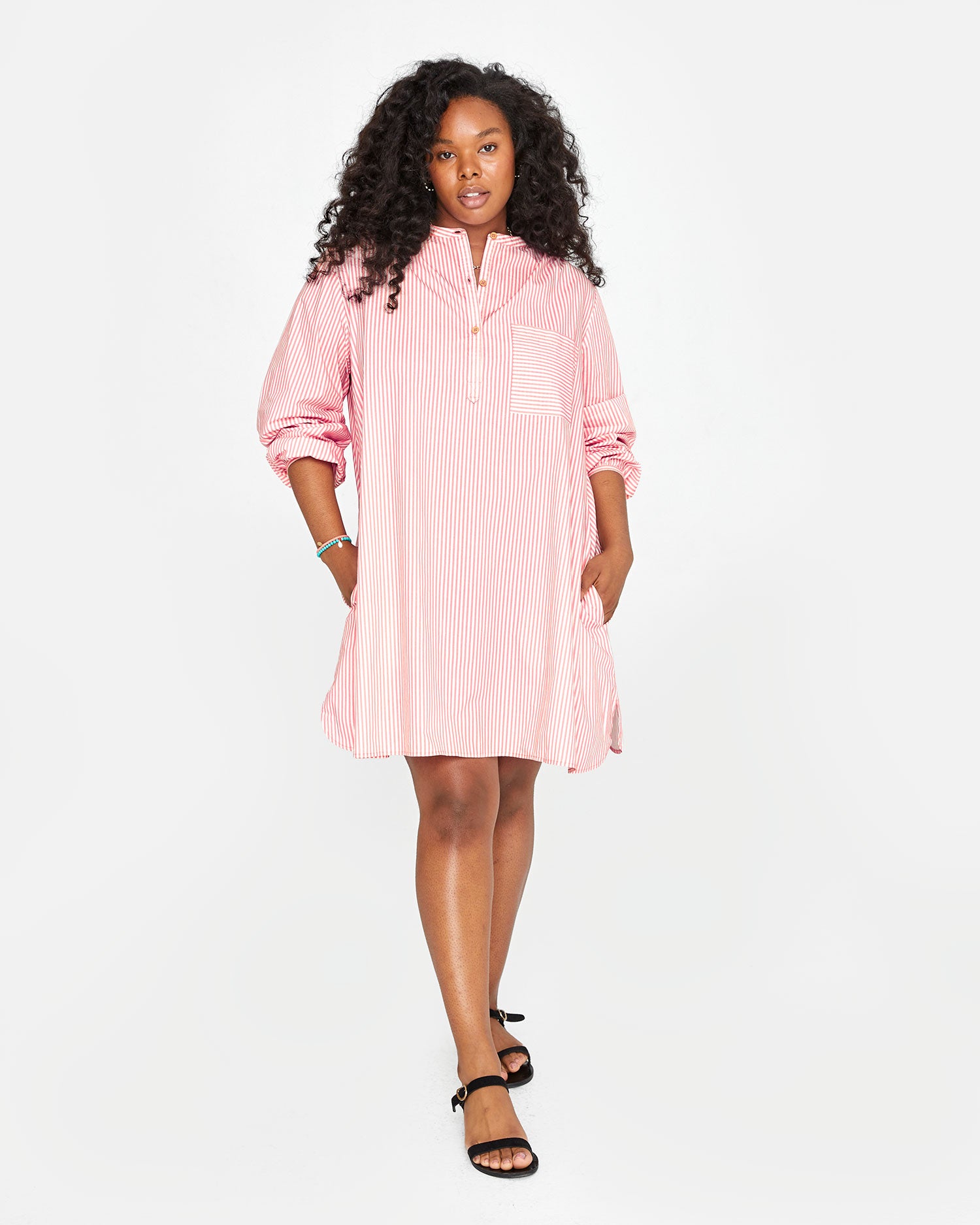 Candice wearing the Flamingo & Cream Stripe St Martin Dress with black sandals