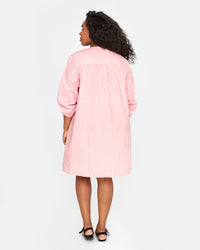back view of candice in the Flamingo & Cream Stripe St Martin Dress