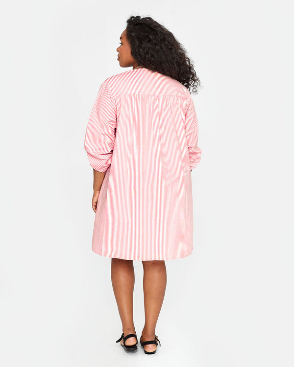 back view of candice in the Flamingo & Cream Stripe St Martin Dress
