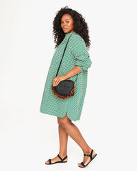 Candice wears the Black Rattan Midi Sac and Tortoise Resin shoulder strap with the St. Martin Dress in Evergreen Rattan